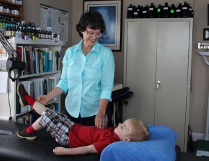 Dr. Fidler demonstrates TBM on a young boy
